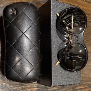 CHANEL Glamorous black sunglasses with gold accents, and quilted case